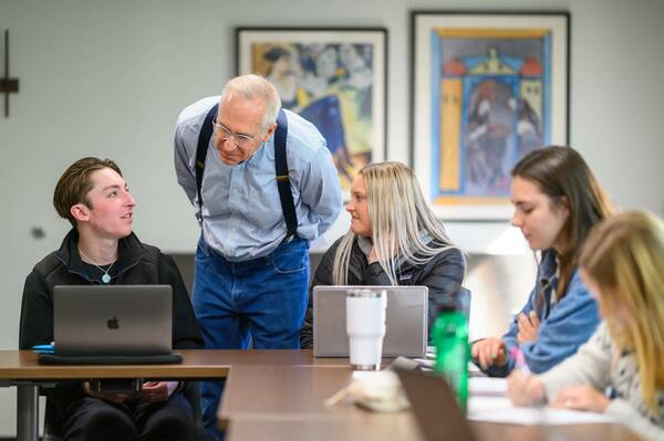 Prof Roche Observing Student With Laptop
